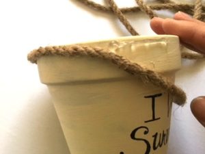 Using dollar store flower pots, rope and paints create a fun message and add a plant. mybrightideasblog.com
