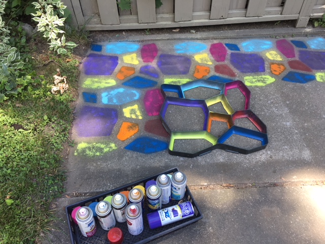 How to make a painted patio by spray painting a concrete slab using a concrete stepping stone mold. mybrightideasblog.com