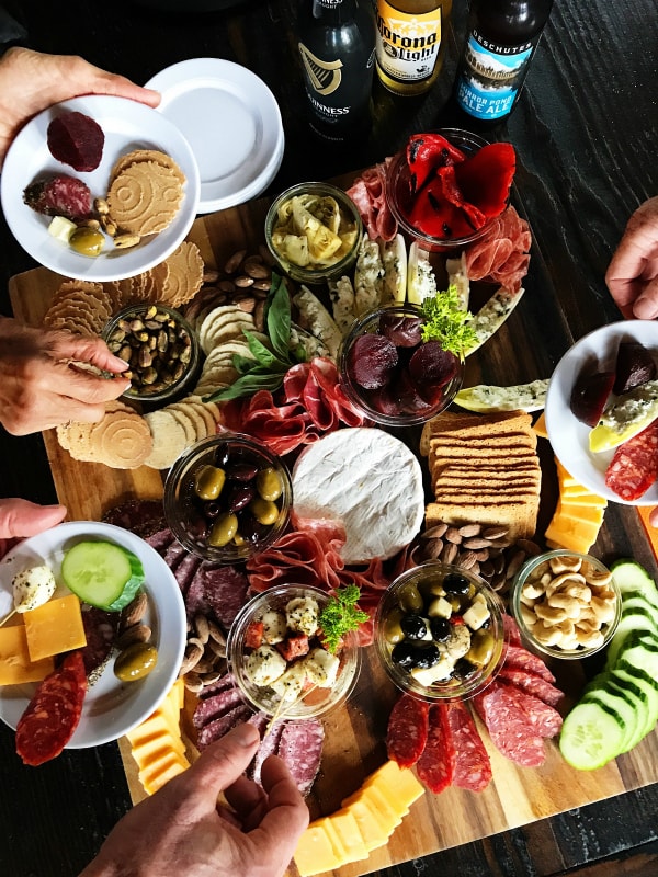 How to make a charcuterie board. Meat and cheese and olives and antipasto.