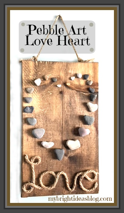 Collect Beach Stones in Heart Shape to creat this pebble and jute rope hanging wall decoration. Great gift idea! mybrightideasblog.com